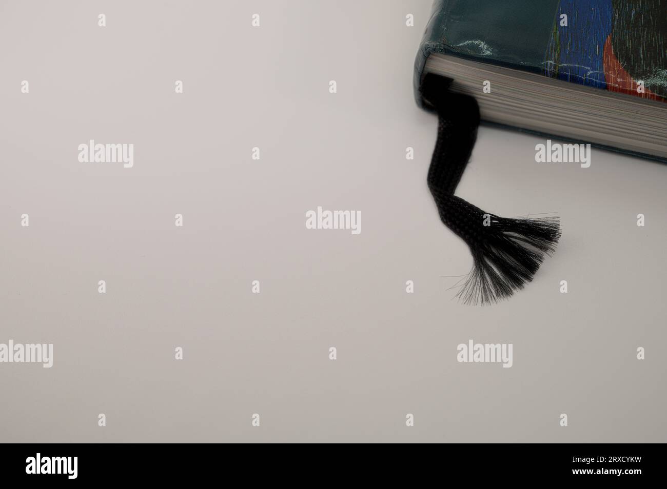 black ribbon as a bookmark on a grey background Stock Photo - Alamy