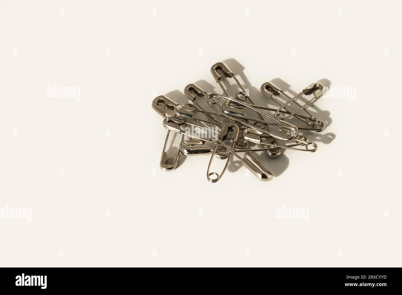 closed safety pins on a white background Stock Photo Alamy