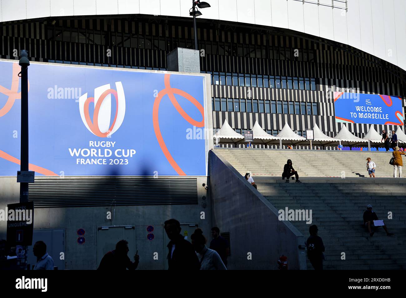 People and Rugby World Cup posters are seen at the entrance to the Orange-Velodrome Stadium. France hosts the 2023 Rugby World Cup from September 8 to October 28, 2023. The South Africa - Tonga match will take place at the Orange-Vélodrome stadium in Marseille on October 1, 2023. Stock Photo