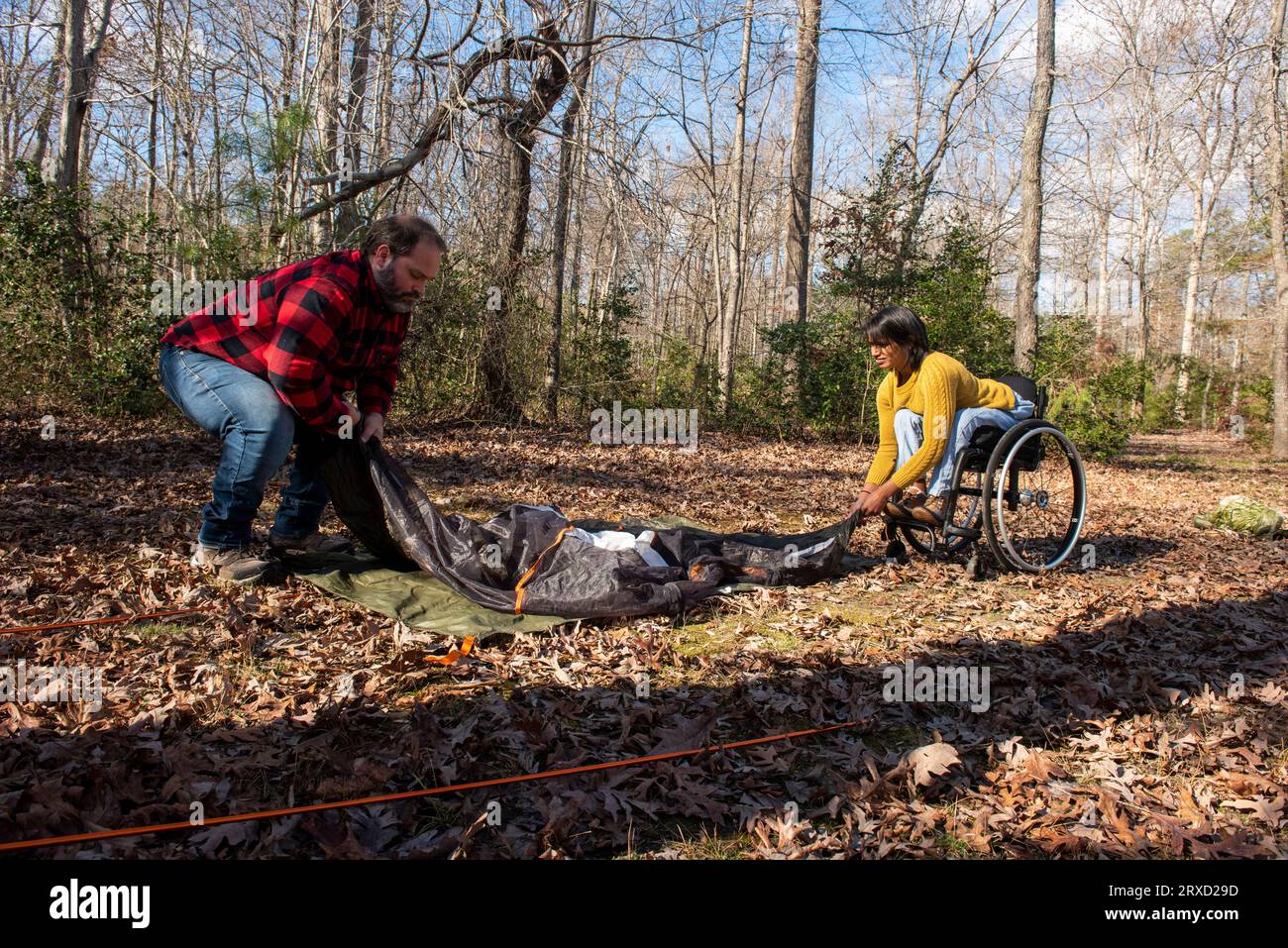 A couple sets up a tent at a campground. Both are disabled but love the outdoors. Stock Photo