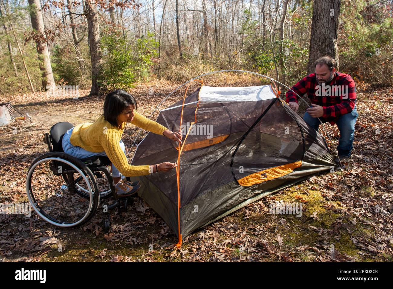 A couple sets up a tent at a campground. Both are disabled but love the outdoors. Stock Photo