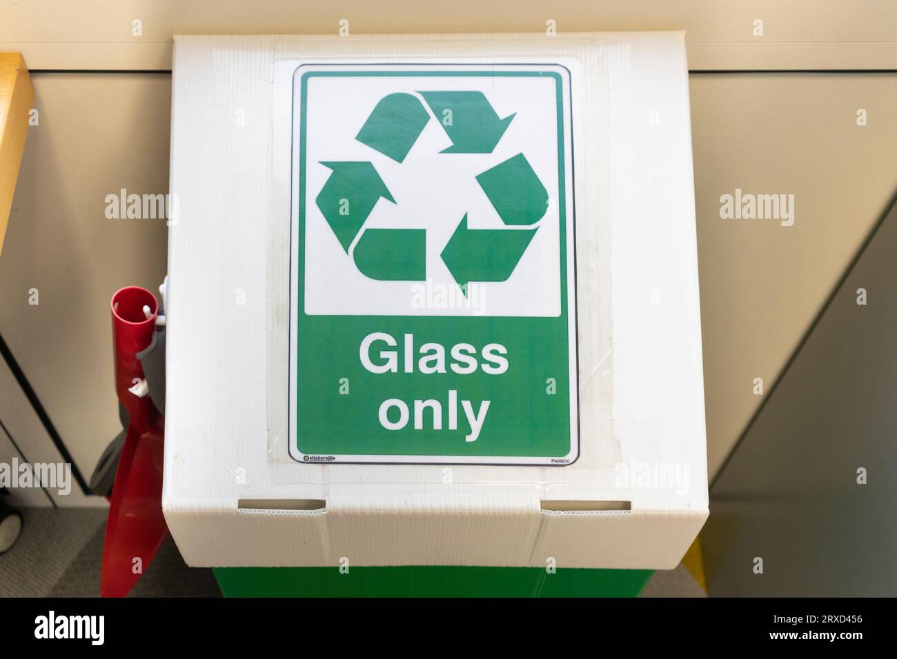 A glass only recycling box in a UK office with a recycling symbol