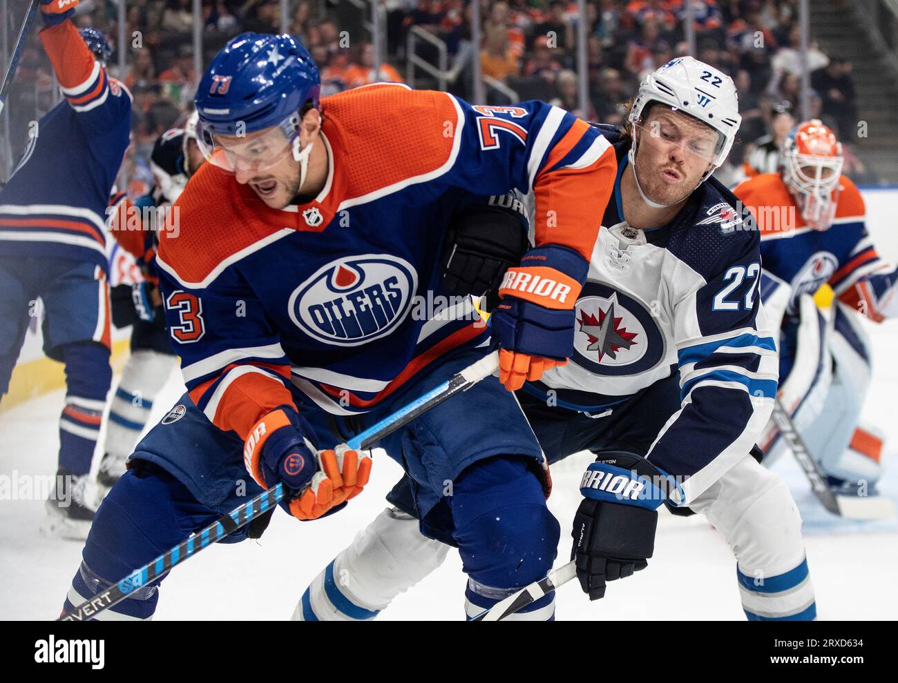 Winnipeg Jets' Mason Appleton (22) battles for the puck with Edmonton Oilers'  Vincent Desharnais (73) during the first period of an NHL preseason hockey  game in Edmonton, Alberta on Sunday, Sept. 24,