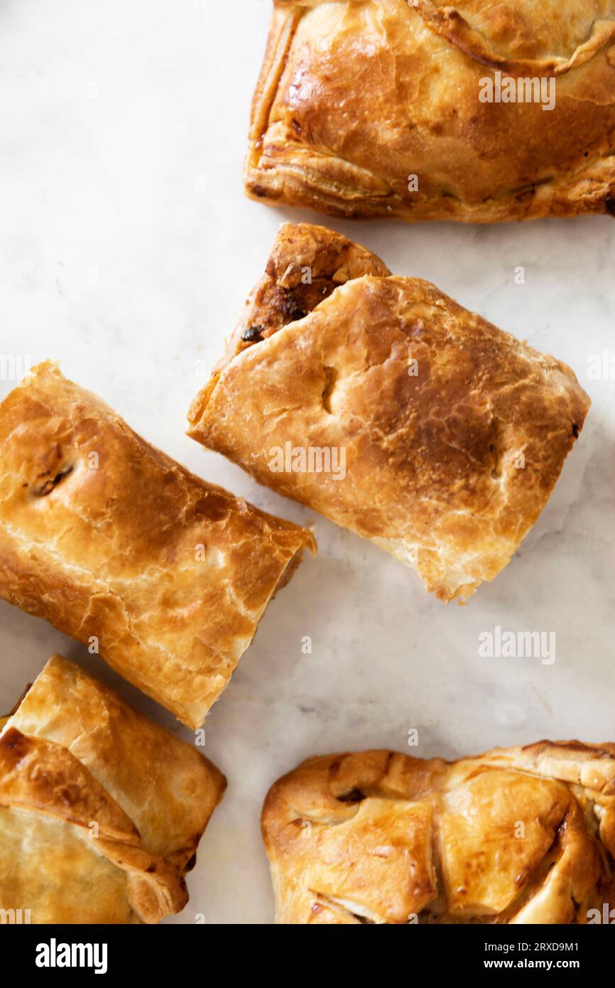 Tasty savory pastries artfully displayed on a white slate, offering delightful flavor. Stock Photo