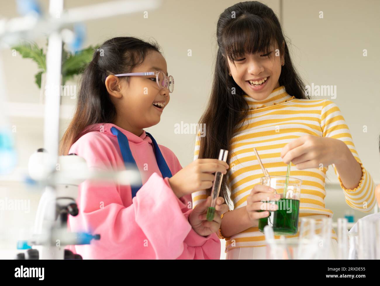 Children scientist doing science experiment test with chemistry in a