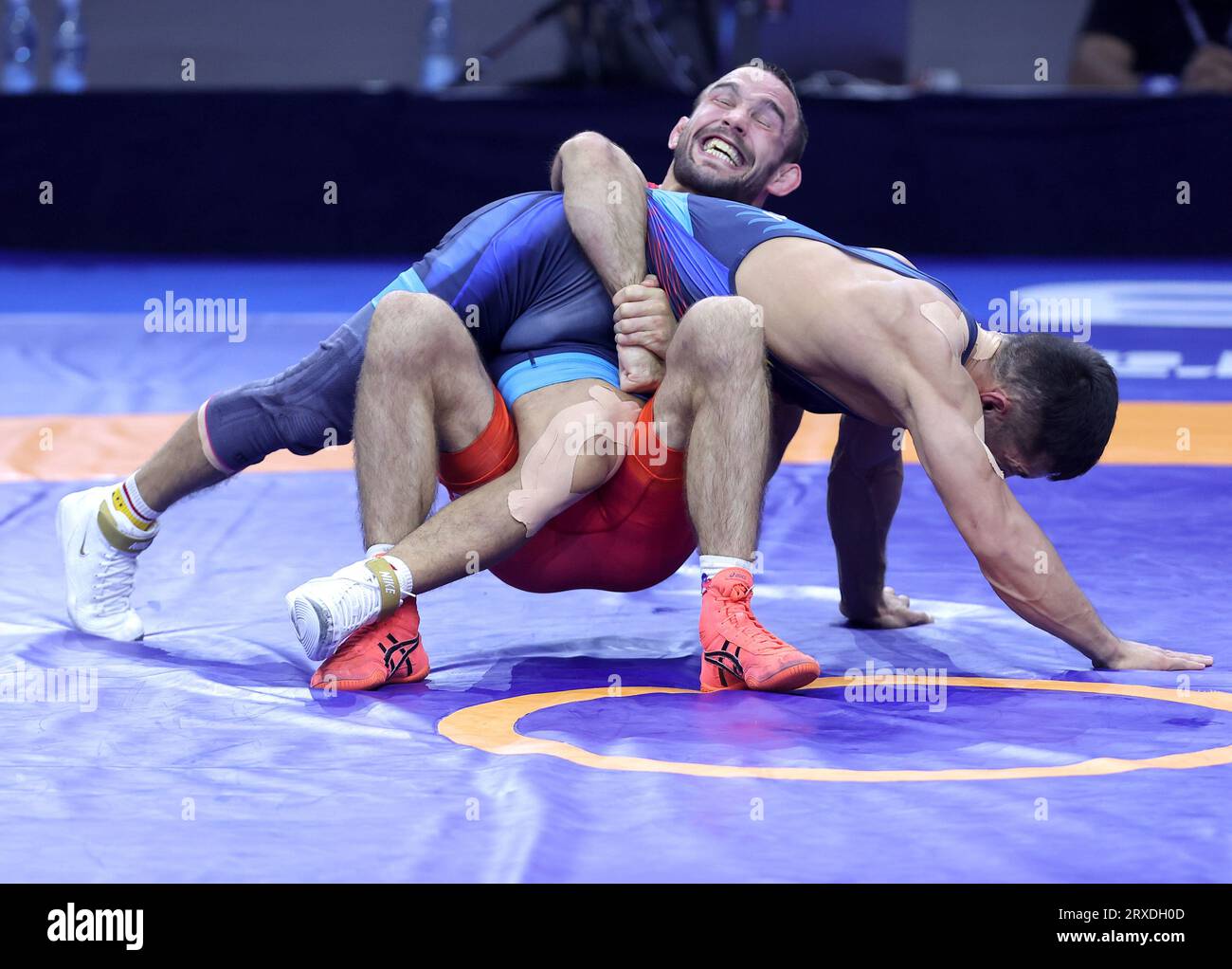 Belgrade. 24th Sep, 2023. Serbia's Mate Nemes (back) and Kyrgyzstan's Amantur Ismailov compete during their match for bronze medal in the men's 67kg Greco-Roman category at the Wrestling World Championships in Belgrade, Serbia on Sept. 24, 2023. Credit: Predrag Milosavljevic/Xinhua/Alamy Live News Stock Photo