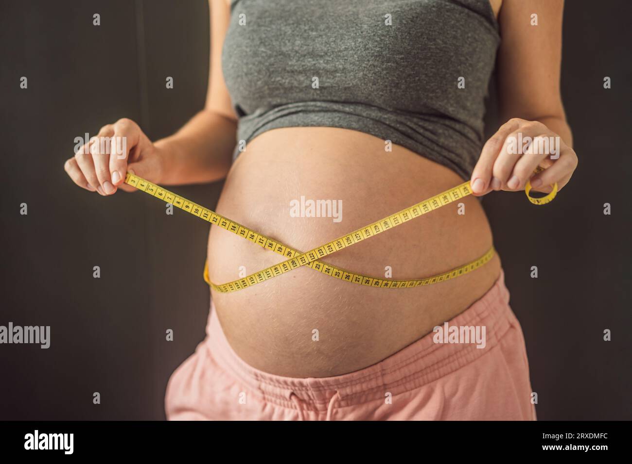 Slim young woman measuring her thin waist with a tape measure, close up  Stock Photo - Alamy