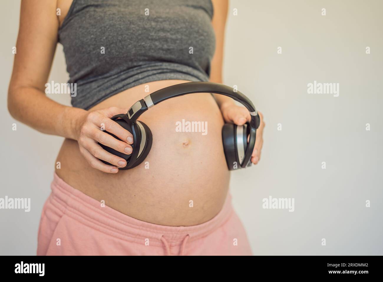 Melodies in the womb: Headphones placed on a pregnant belly, bonding  through music, a heartwarming connection between mother and baby Stock  Photo - Alamy
