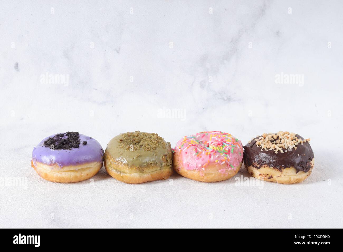 Delicious sweet donuts with different flavors on a table. Isolated ...