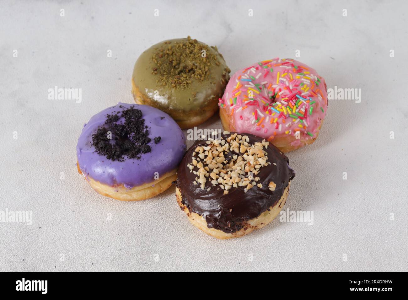 Delicious sweet donuts with different flavors on a table. Isolated ...
