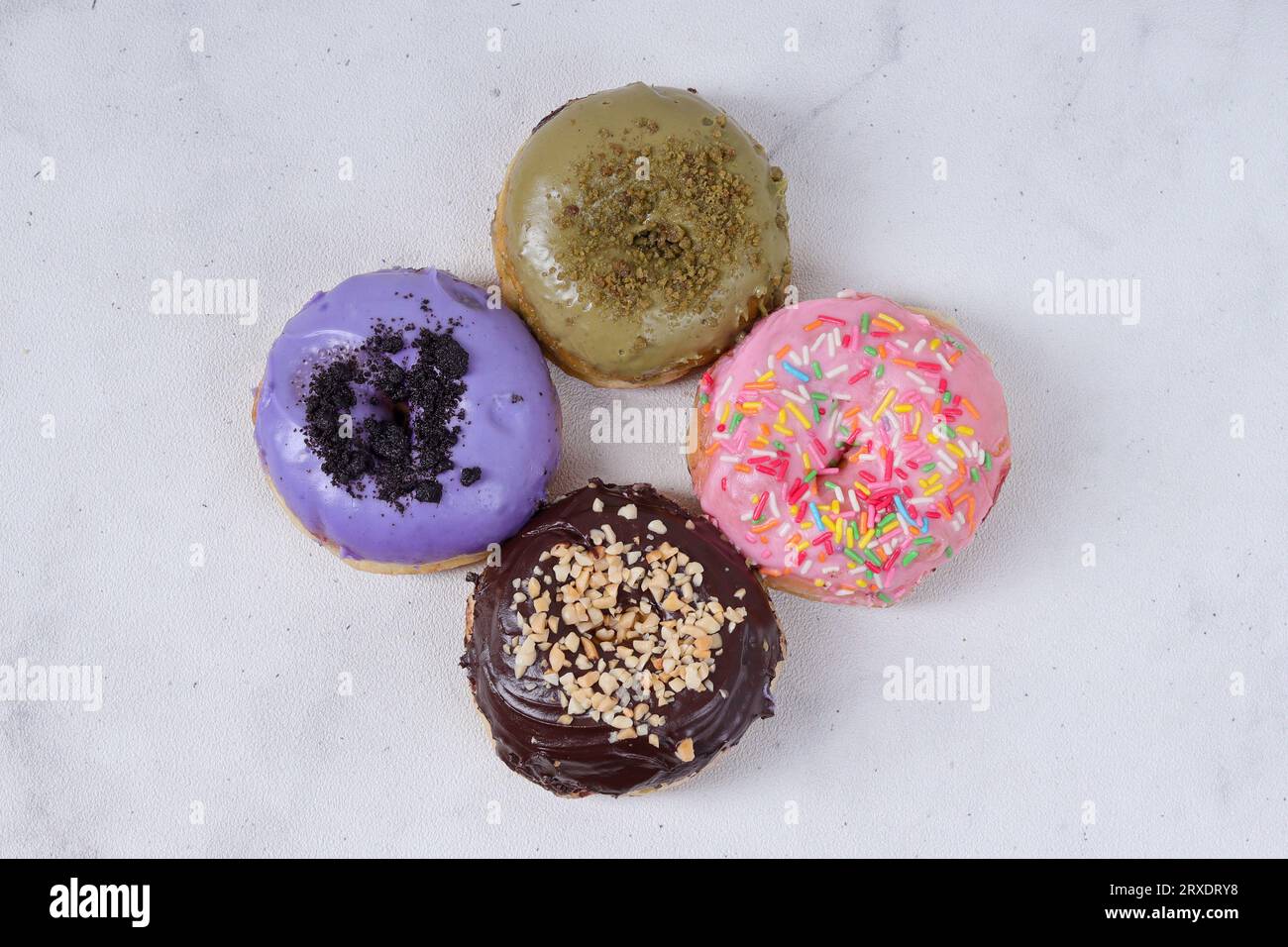 Flat lay top view of delicious sweet donuts with different flavors on a ...