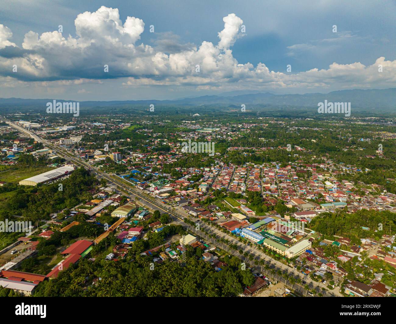 Tagum City, aerial survey at daytime. Buildings and highway with land transportation. Davao del