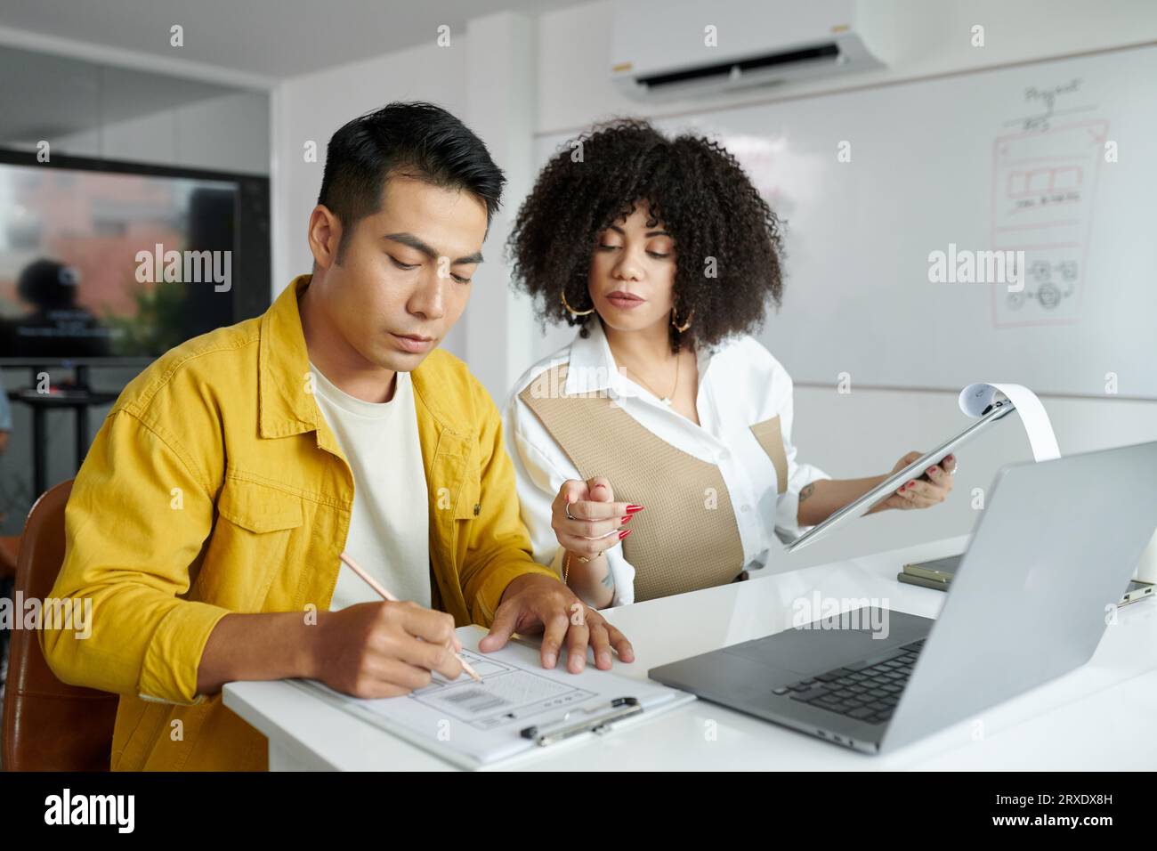 UI and UX designers working on new website interface wireframe Stock Photo