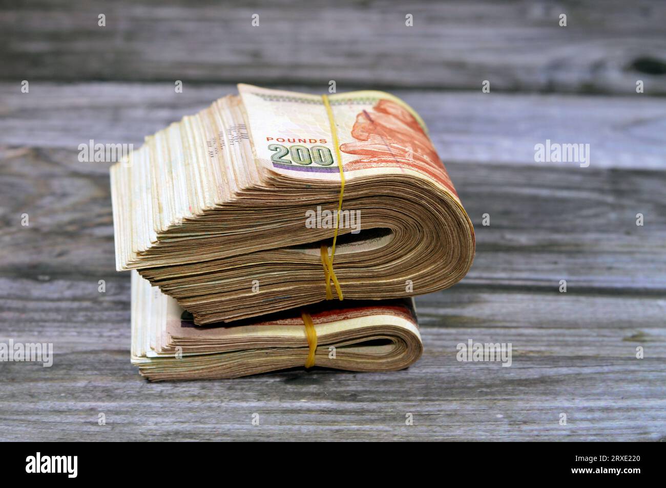 Folded Egyptian money isolated on wooden background, 200 LE two hundred ...