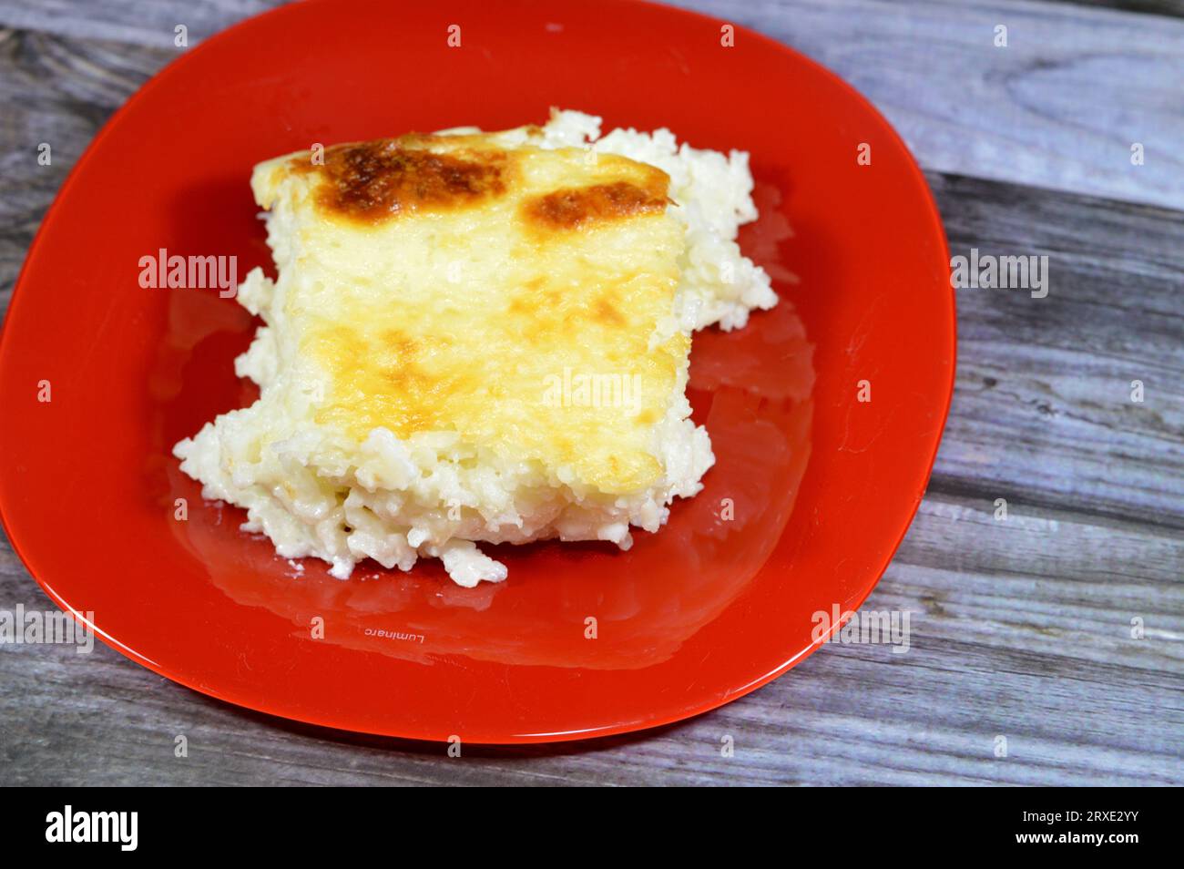 Baked Egyptian rice or Roz muammar's combination of rice, fresh cream, milk, ghee or butter, a very popular Egyptian dish, a simple, sumptuous Egyptia Stock Photo