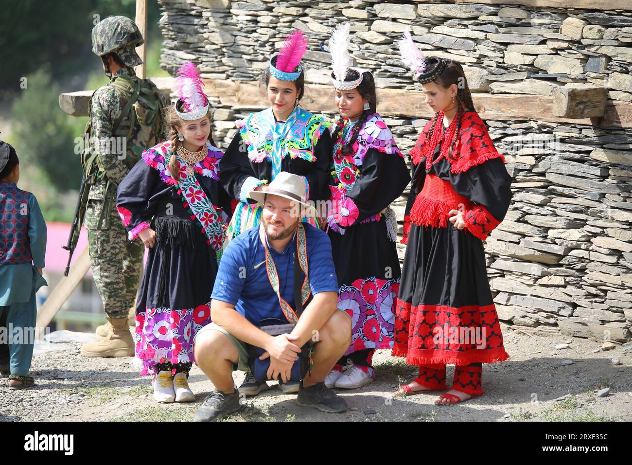 22 august 2023: Foreign tourists with kalash tribe durring uchal festival, rumbur valley, chitral, pakistan. Stock Photo