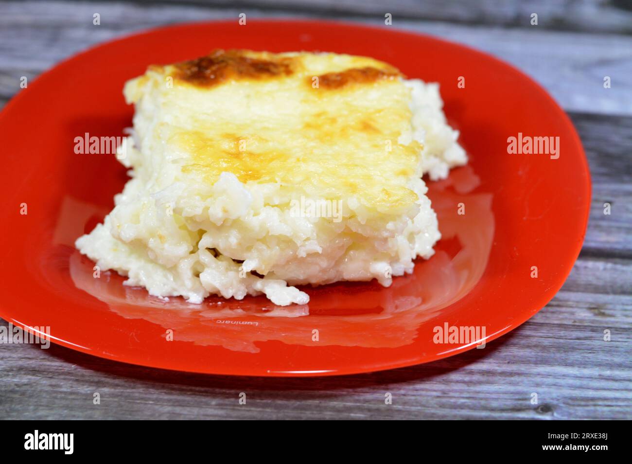 Baked Egyptian rice or Roz muammar's combination of rice, fresh cream, milk, ghee or butter, a very popular Egyptian dish, a simple, sumptuous Egyptia Stock Photo