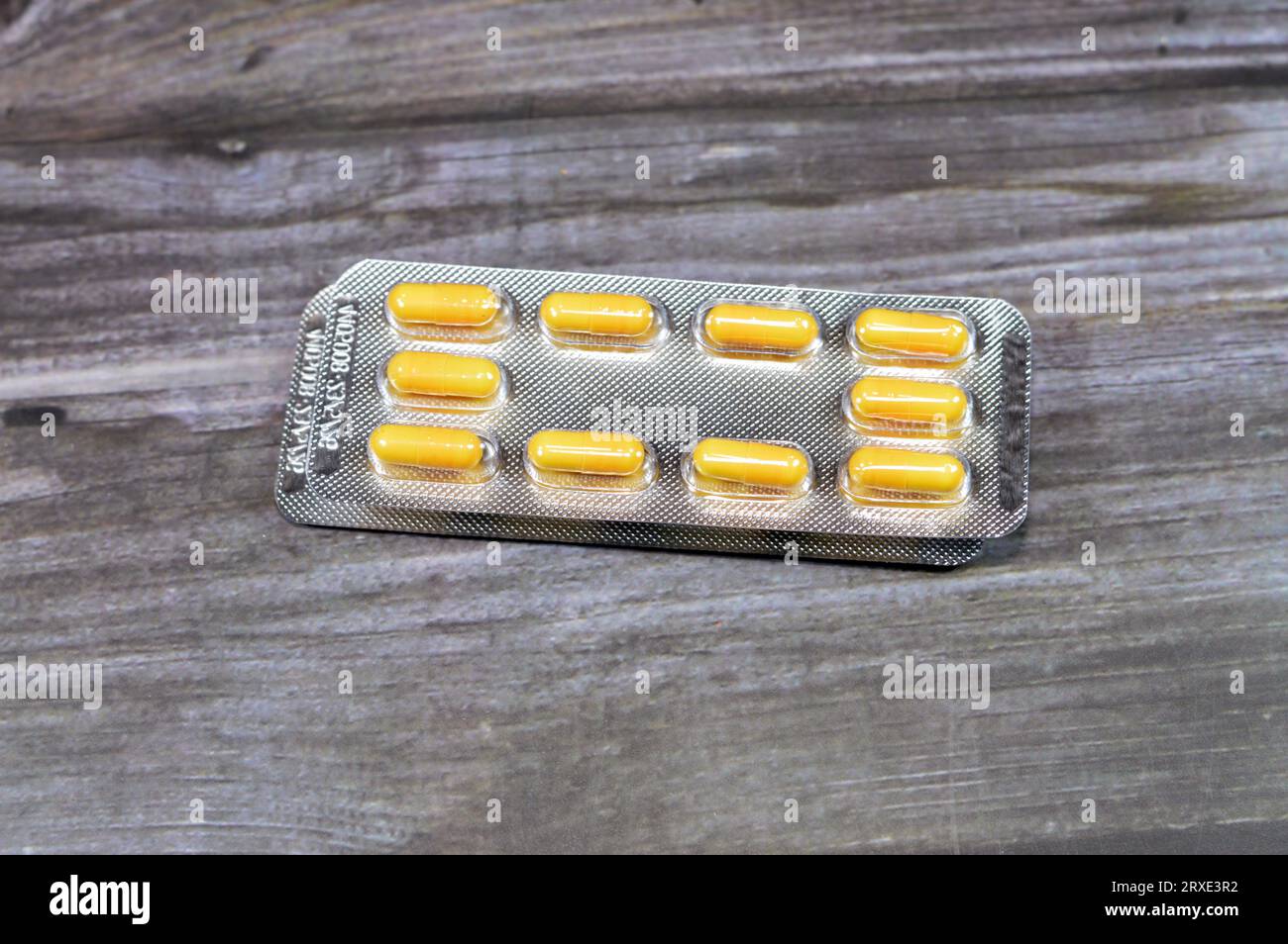 Medication capsules, yellow capsules, treatment, remedy, drug usage, abuse, prescription concept, painkillers and antibiotics, analgesics, taking a me Stock Photo