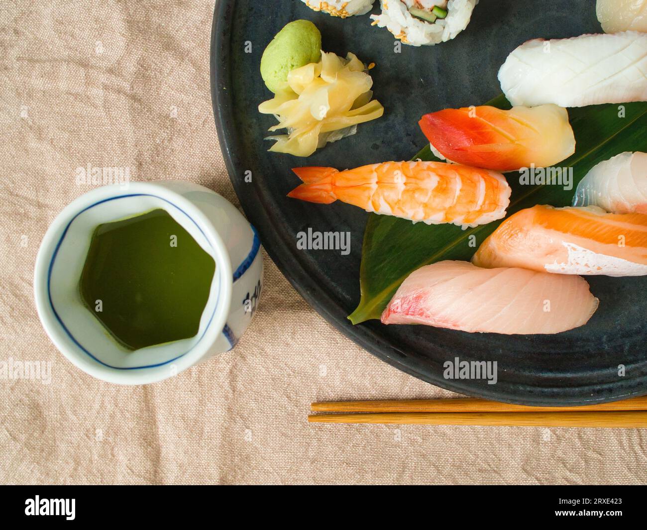 Top down flat lay of colorful Japanese sushi and green tea Stock Photo