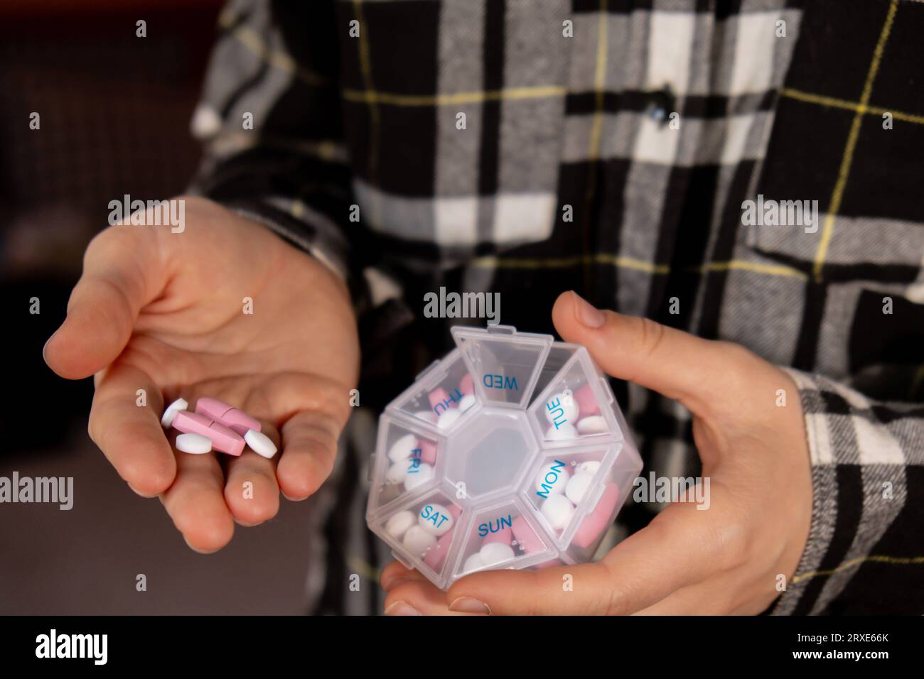 Female hands sorting pills Organizer weekly shots Closeup of medical