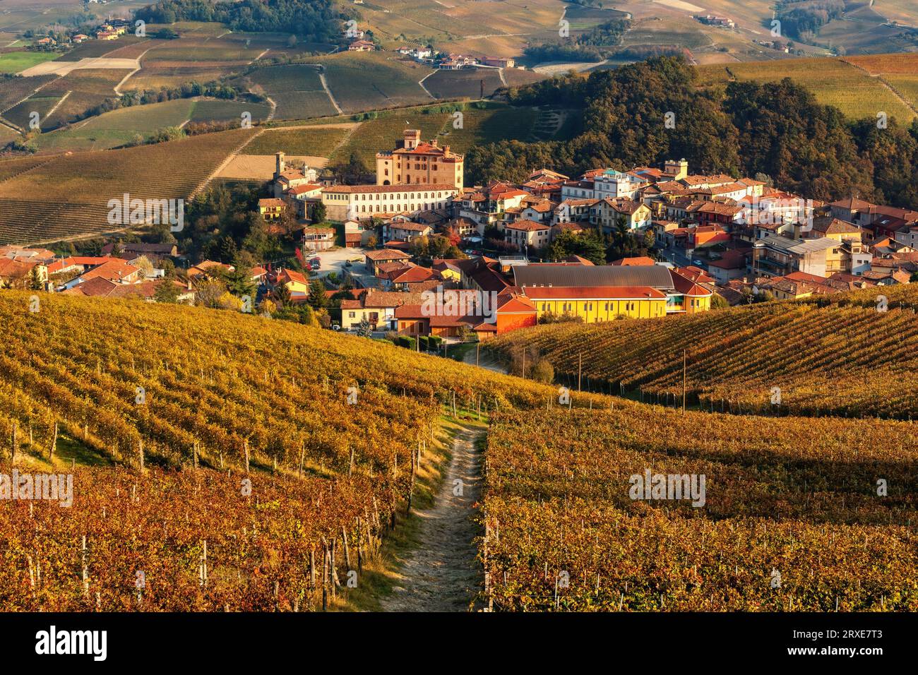 View of the hills with autumnal vineyards and small town of Barolo in Piedmont, Italy. Stock Photo