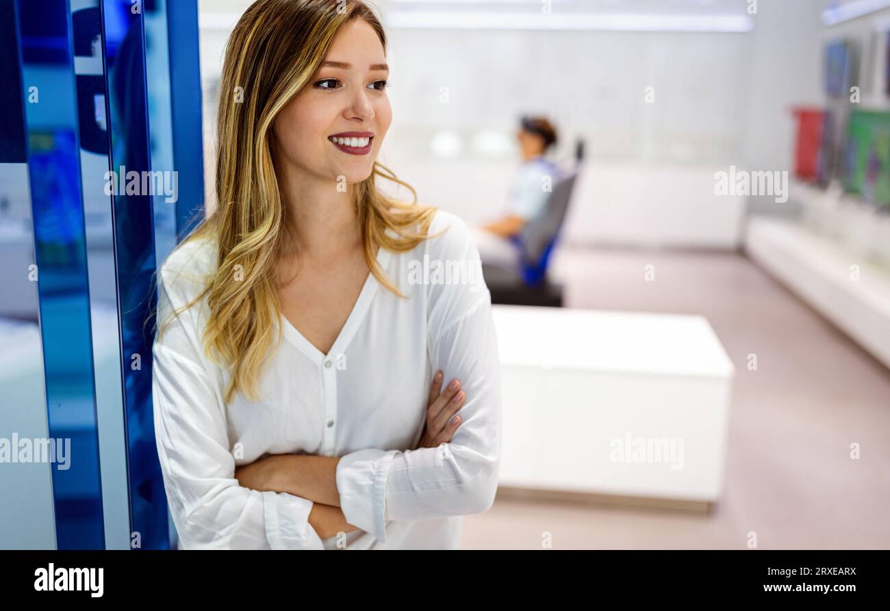 Successful businesswoman standing in a creative office while smiling. Stock Photo