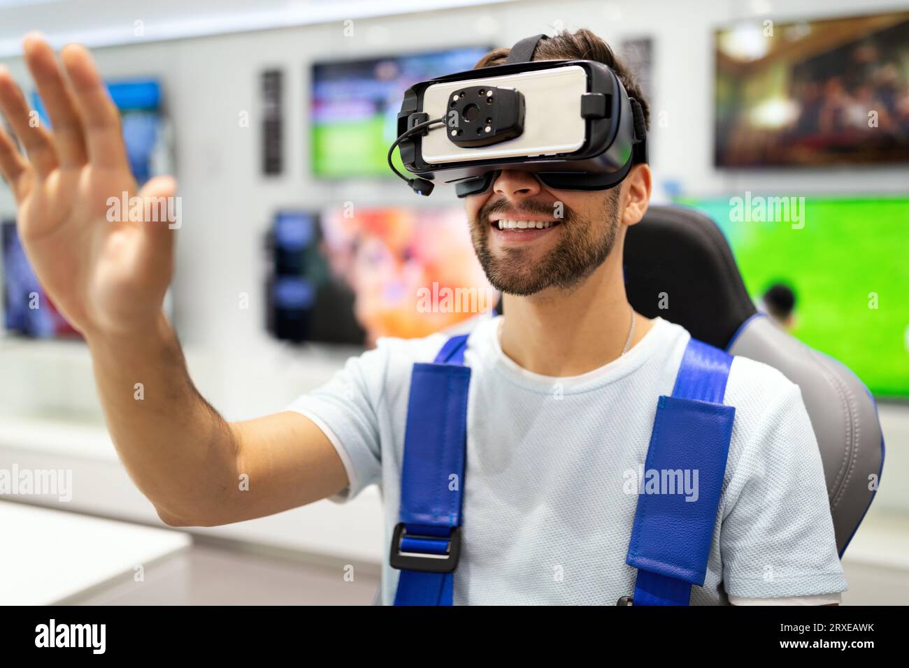 Portrait of man using virtual reality headset at exhibition show. VR technology simulation concept Stock Photo