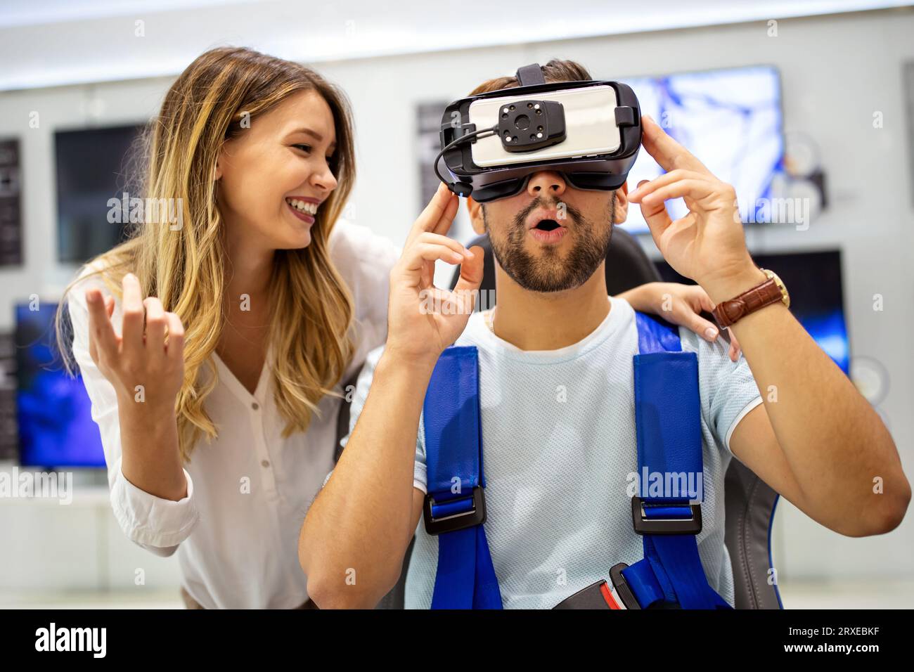Couple enjoying with VR goggles at tech store. Shopping couple having fun at marketplace. Stock Photo