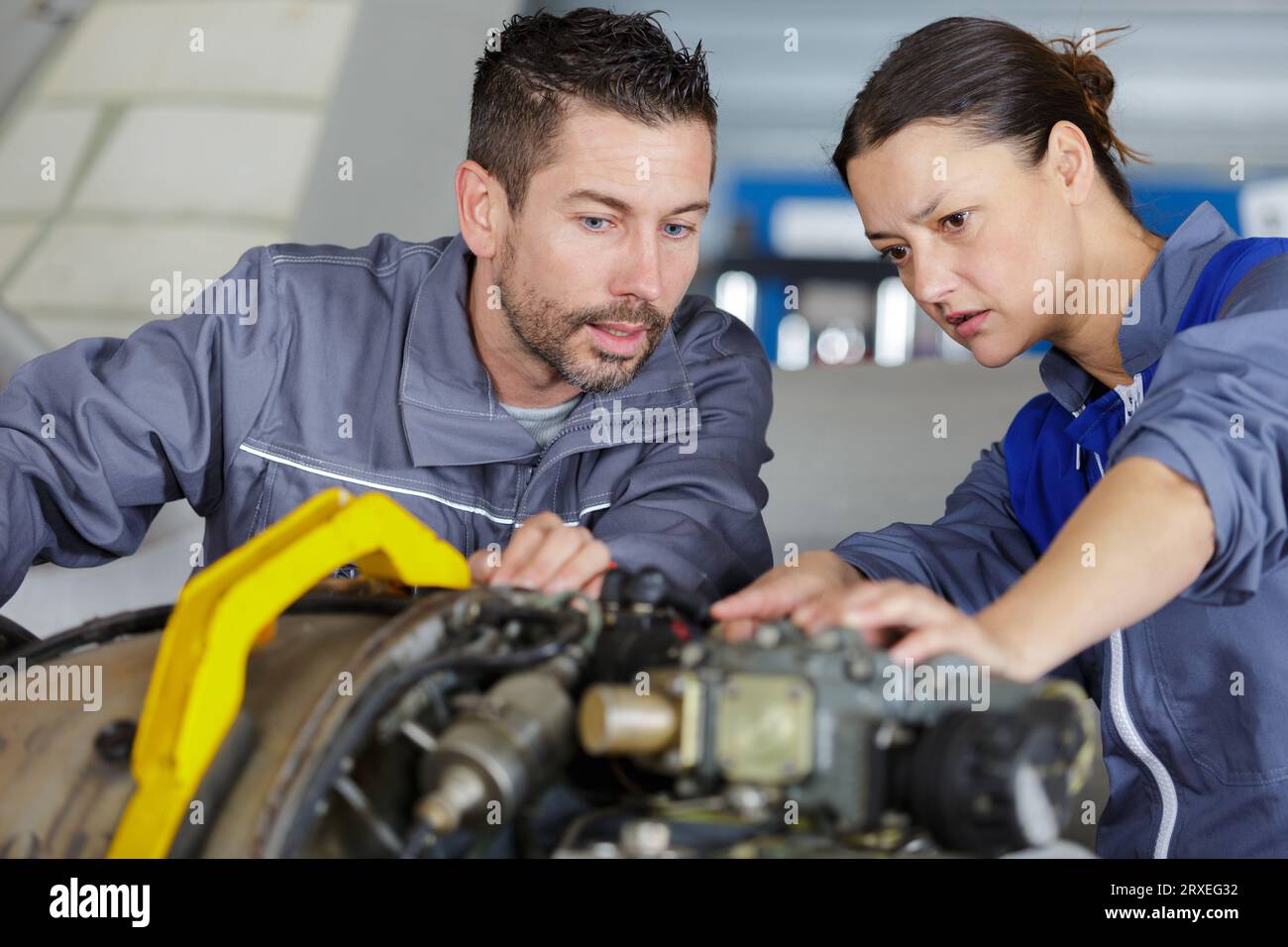 mechanics working on a enginee Stock Photo