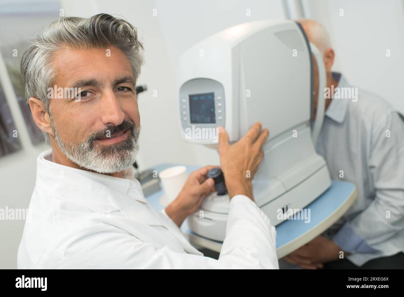 happy ophthalmic testing with device machine Stock Photo Alamy