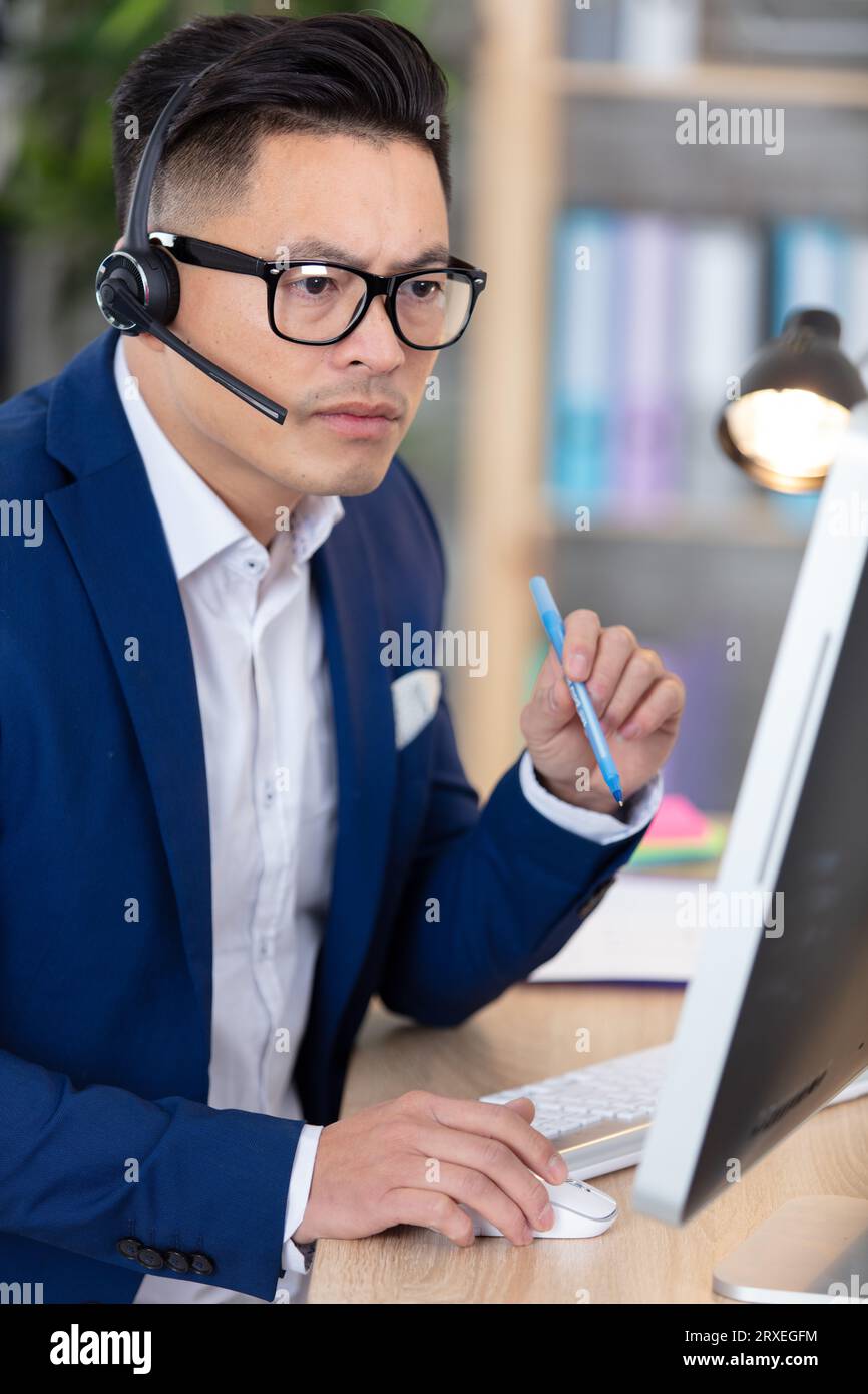 serious asian businessman using a computer Stock Photo