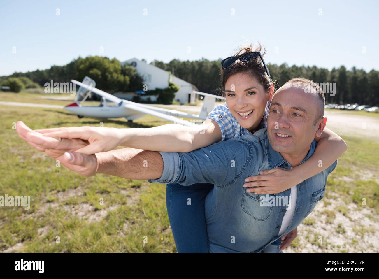 beautiful stylish couple hugging in front of airplane Stock Photo - Alamy