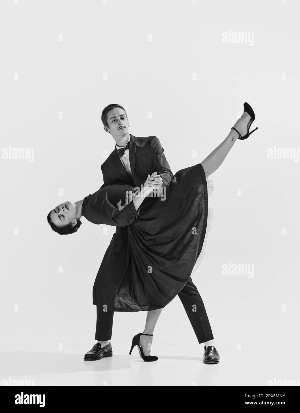 20s-30s era. Beautiful young couple, man and woman in elegant clothes dancing lindy hop. Black and white. Stock Photo