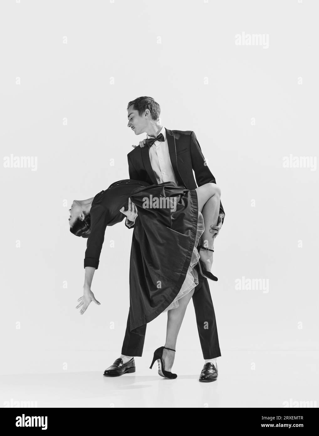 Elegance and passion. Black and white. Attractive young woman and handsome man dancing lindy hop. Stock Photo