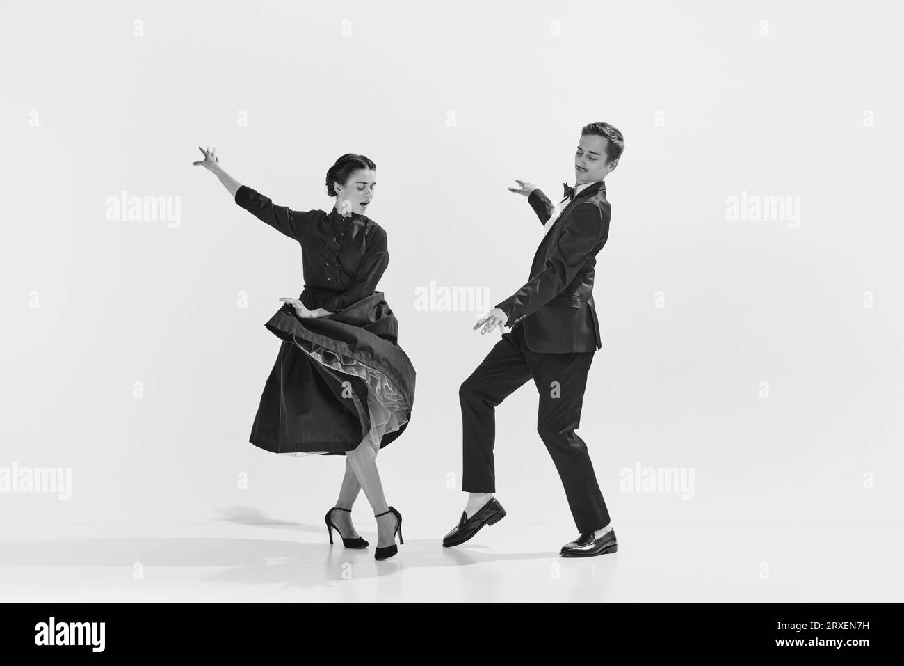 Rhythmic. Black and white. Stylish, elegant young couple, man and woman in stylus clothes dancing Stock Photo