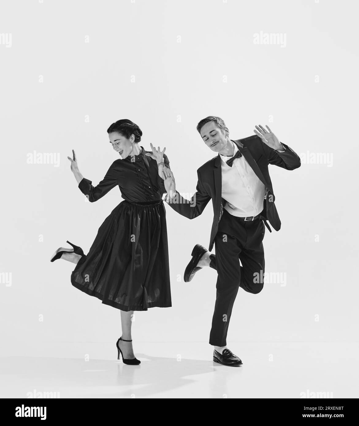 Rhythmic. Black and white. Stylish, elegant young couple, man and woman in stylus clothes dancing Stock Photo