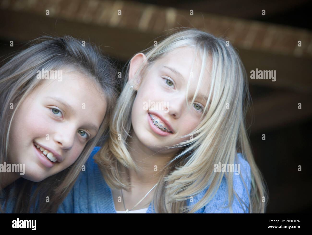 Two young girls smiling at the camera. Stock Photo
