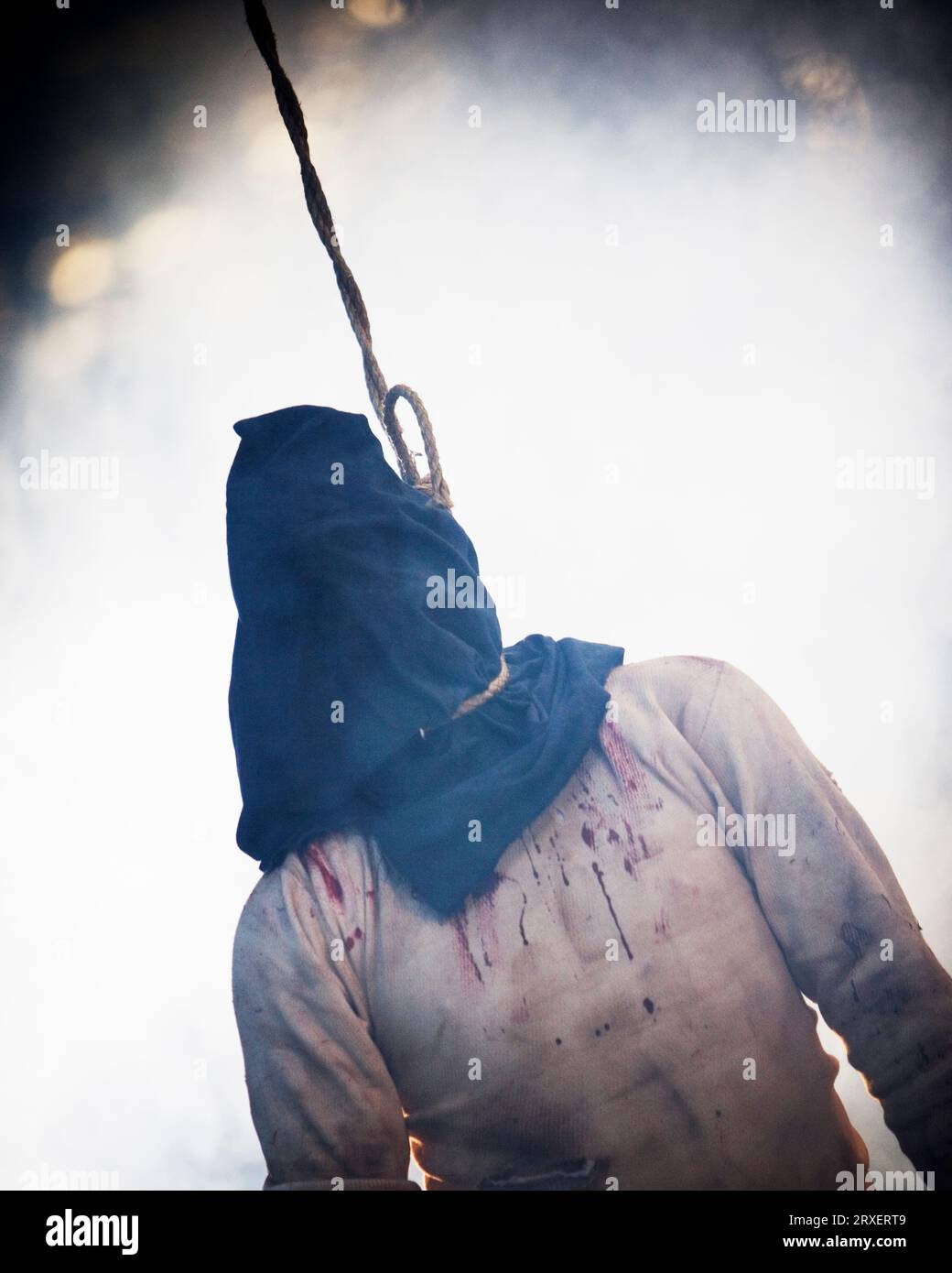 Hooded hanging man. Stock Photo