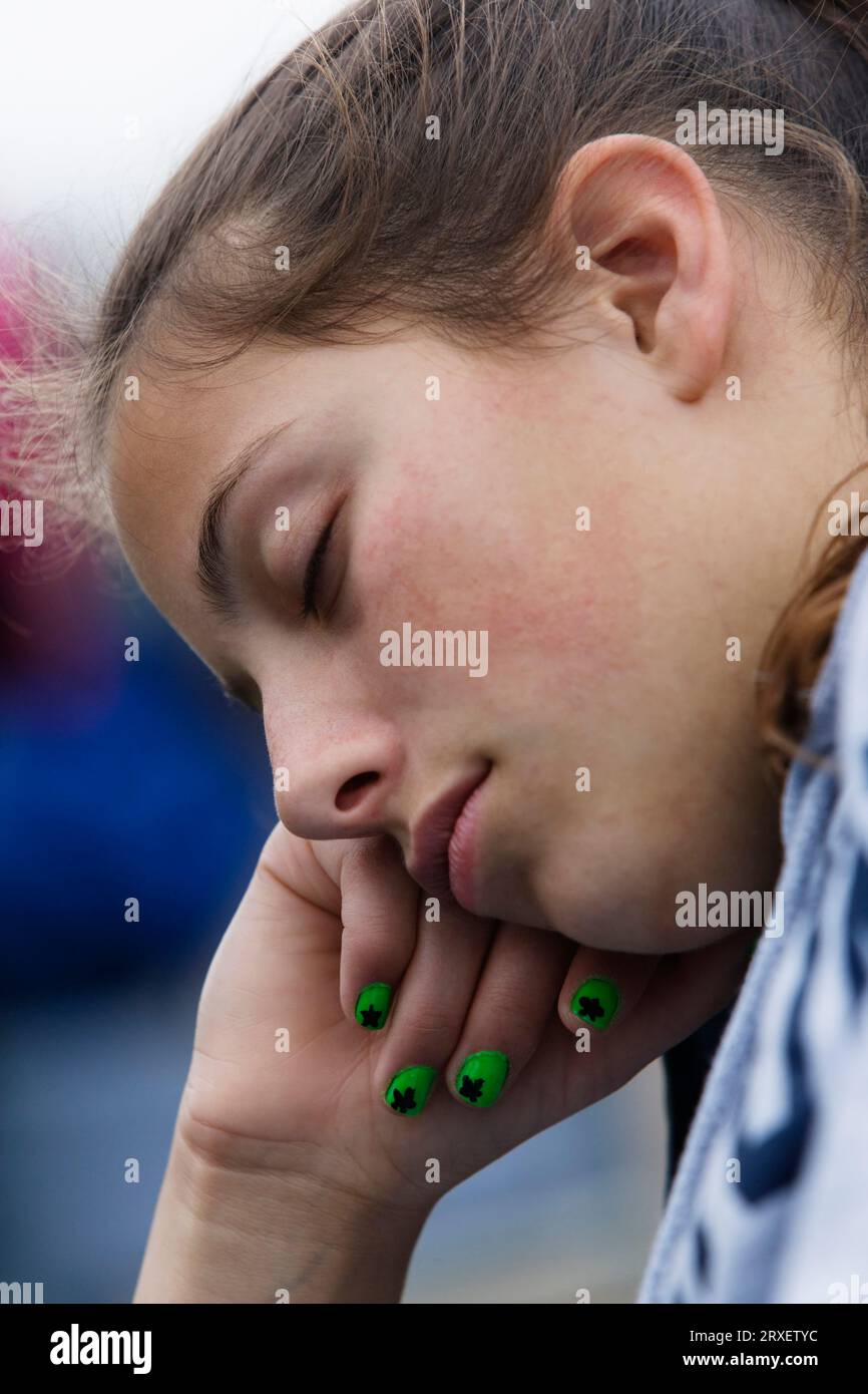 A young girl sleeping with her head on her hand Stock Photo - Alamy