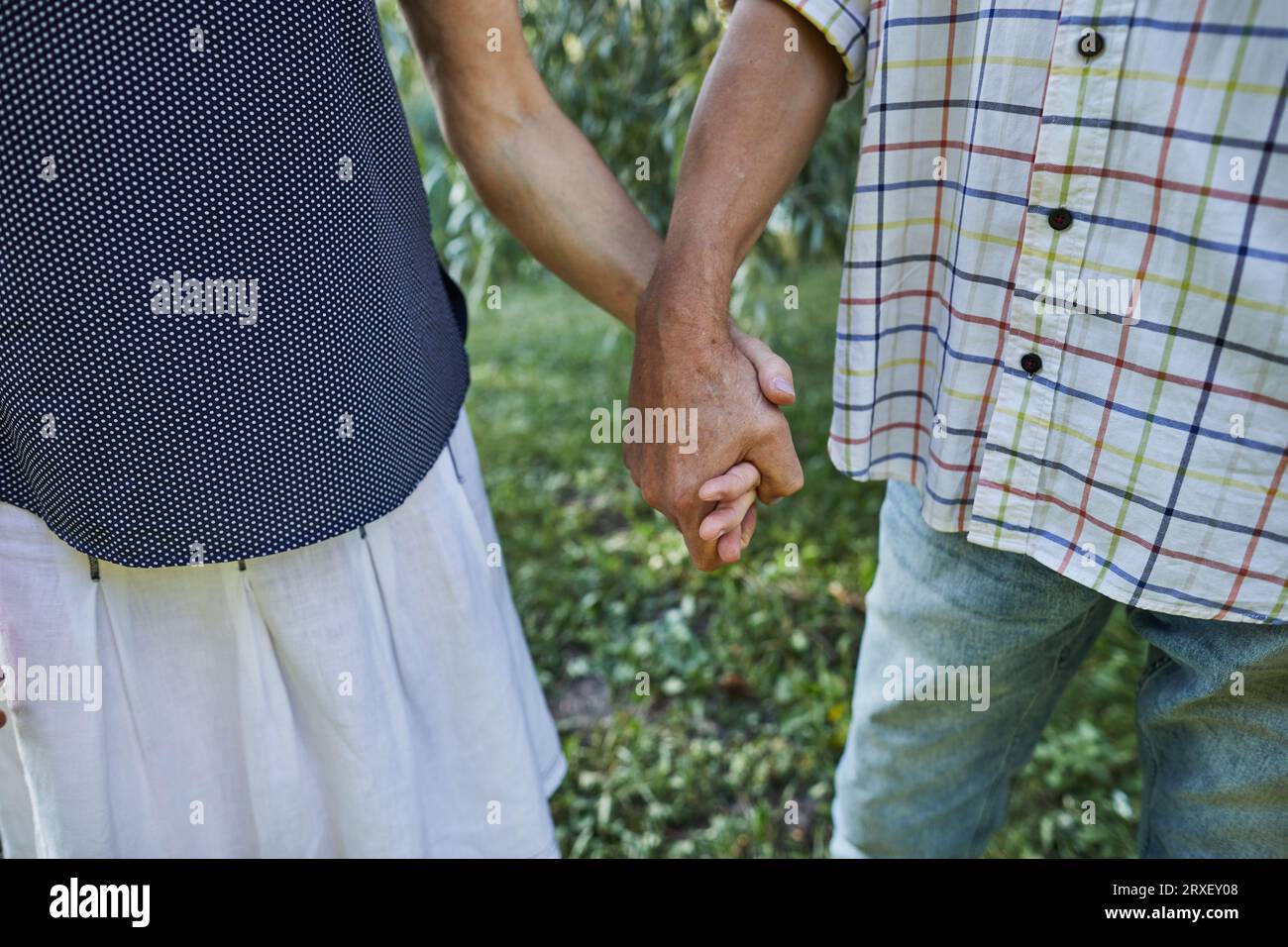 senior man and woman holding each other's hands Stock Photo