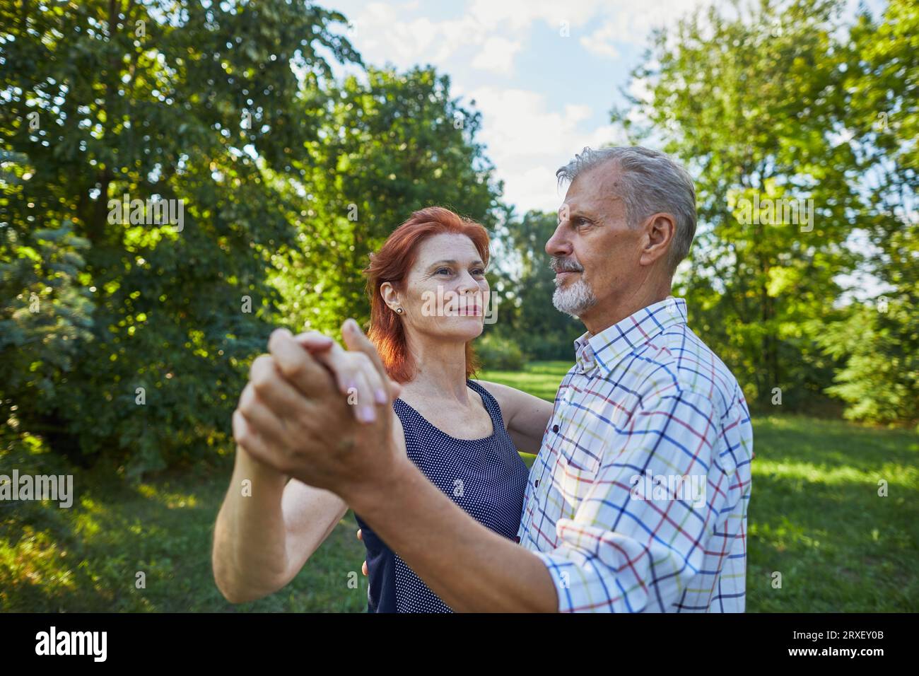senior couple dancing on outdoor and looking away Stock Photo