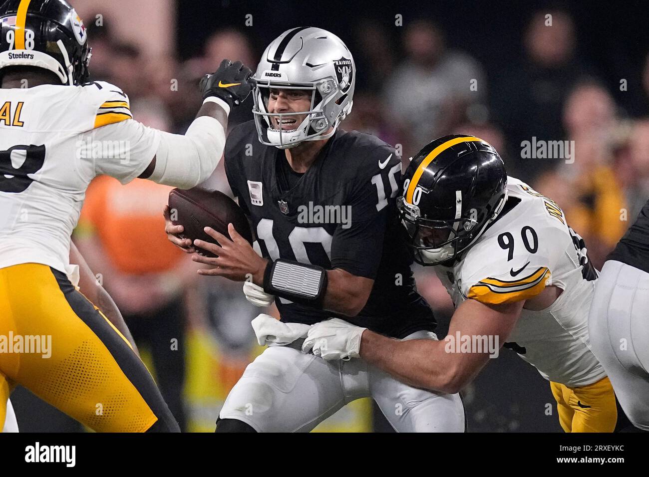 Las Vegas Raiders quarterback Jimmy Garoppolo, center, is sacked by  Pittsburgh Steelers linebacker T.J. Watt, right, as defensive end DeMarvin  Leal runs in during an NFL football game Sunday, Sept. 24, 2023