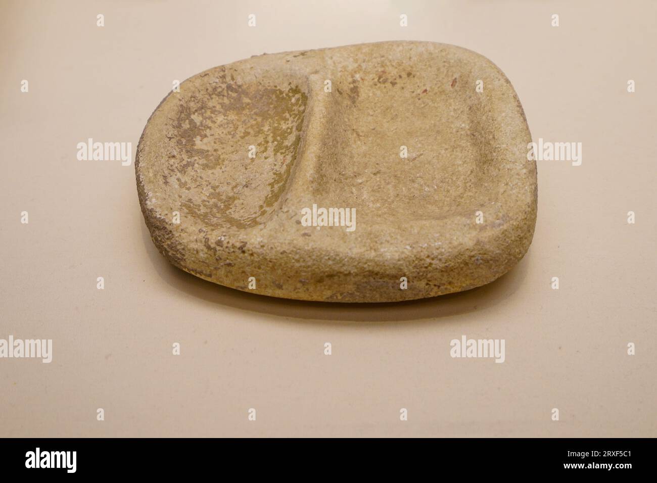 Beijing China, February 17, 2023: Yangshao culture Double grid Stone Grinding Plate in the National Museum of China. Stock Photo