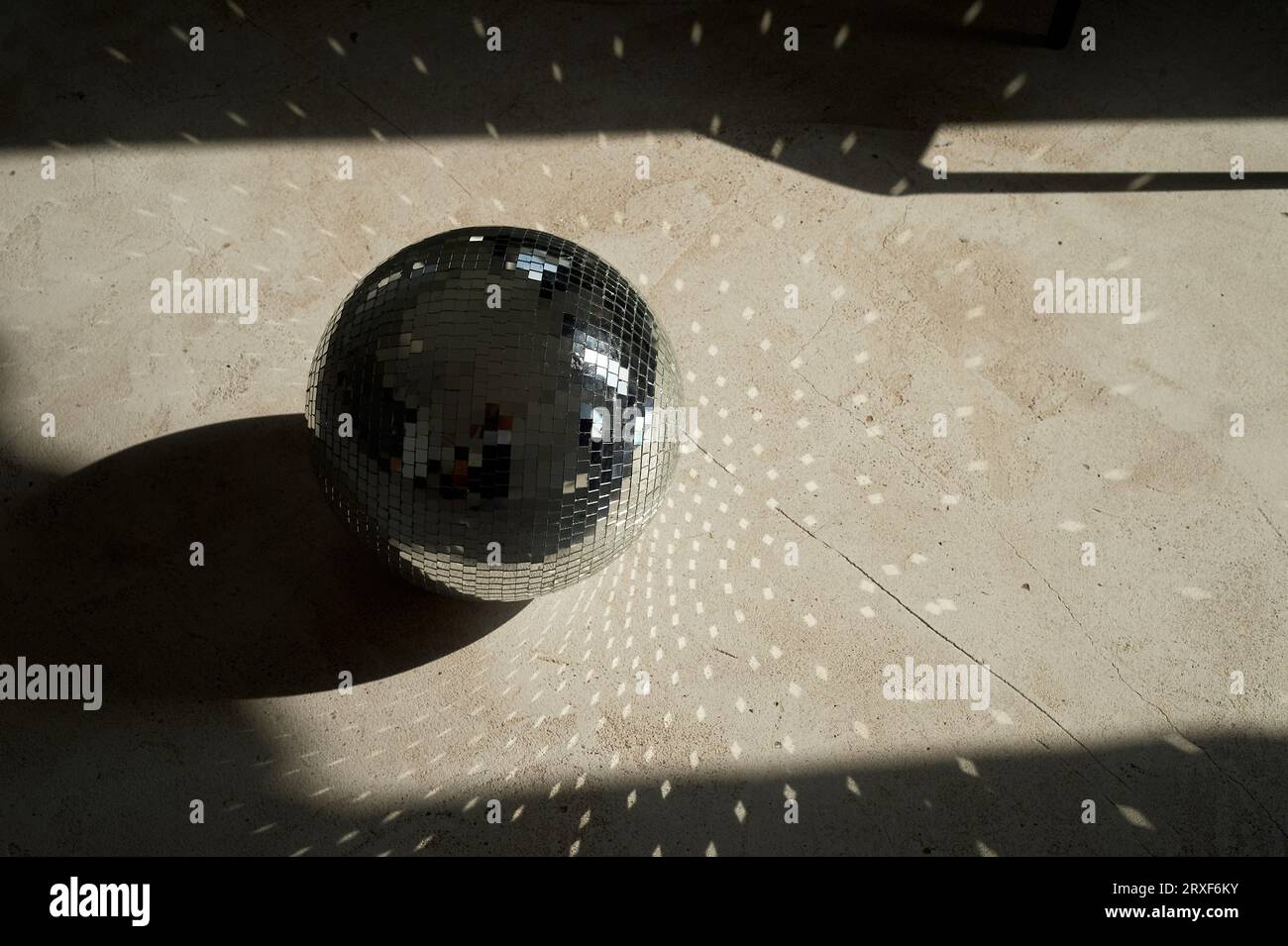 Disco ball with hard light and shadows. Party times Stock Photo