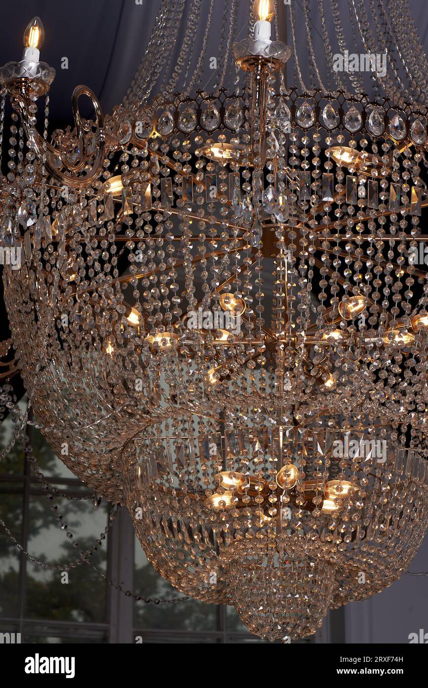 Heavy crystal chandelier with a ceiling decorated with fabrics. Palace