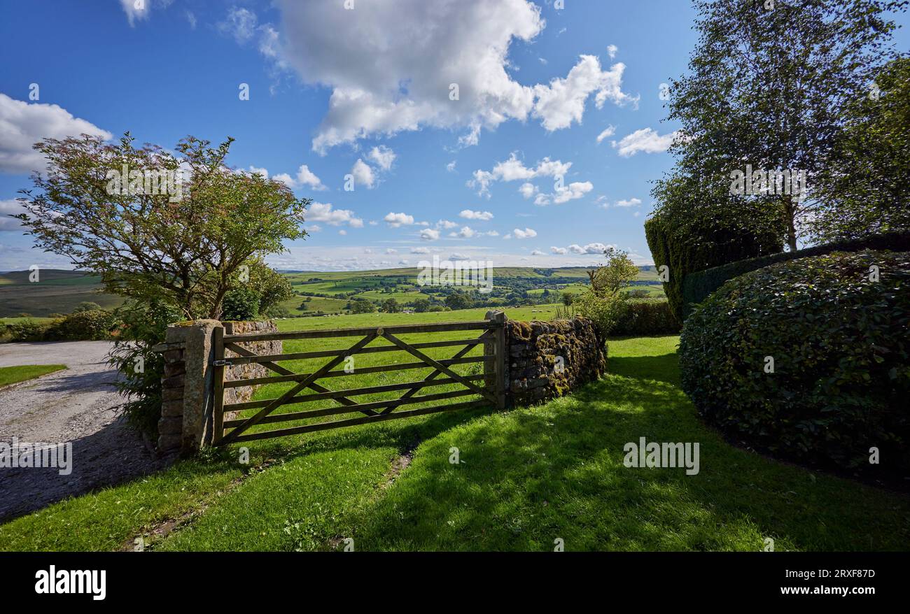 With a wooden farm gate, a bright and sunny August afternoon looking south towards Draughton Moor from Halton East Stock Photo