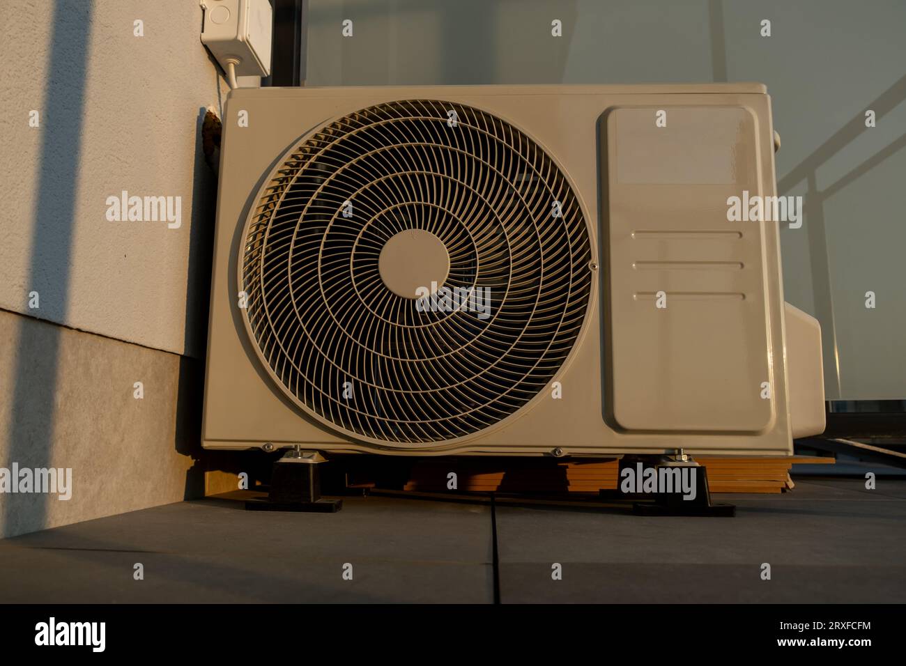 Outdoor air conditioning unit on surface of balcony of apartment Stock