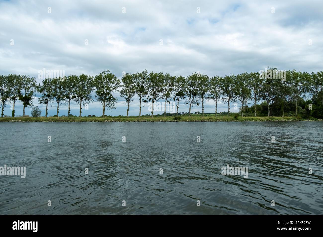 A serene natural landscape featuring a body of water surrounded by a ...
