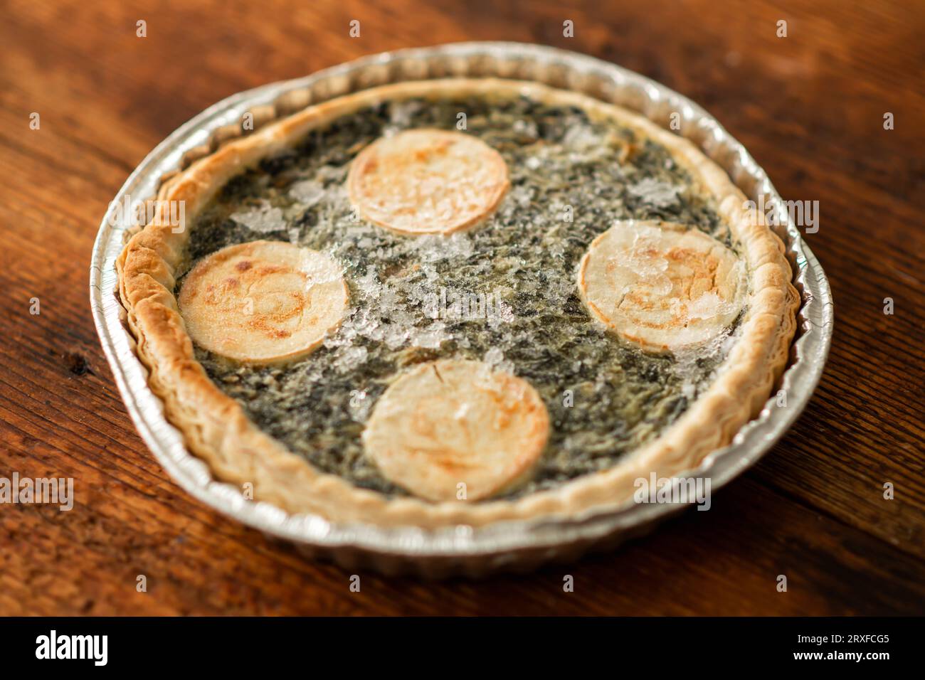 An image of a frozen cheese and spinach quiche, a perfect semi-finished