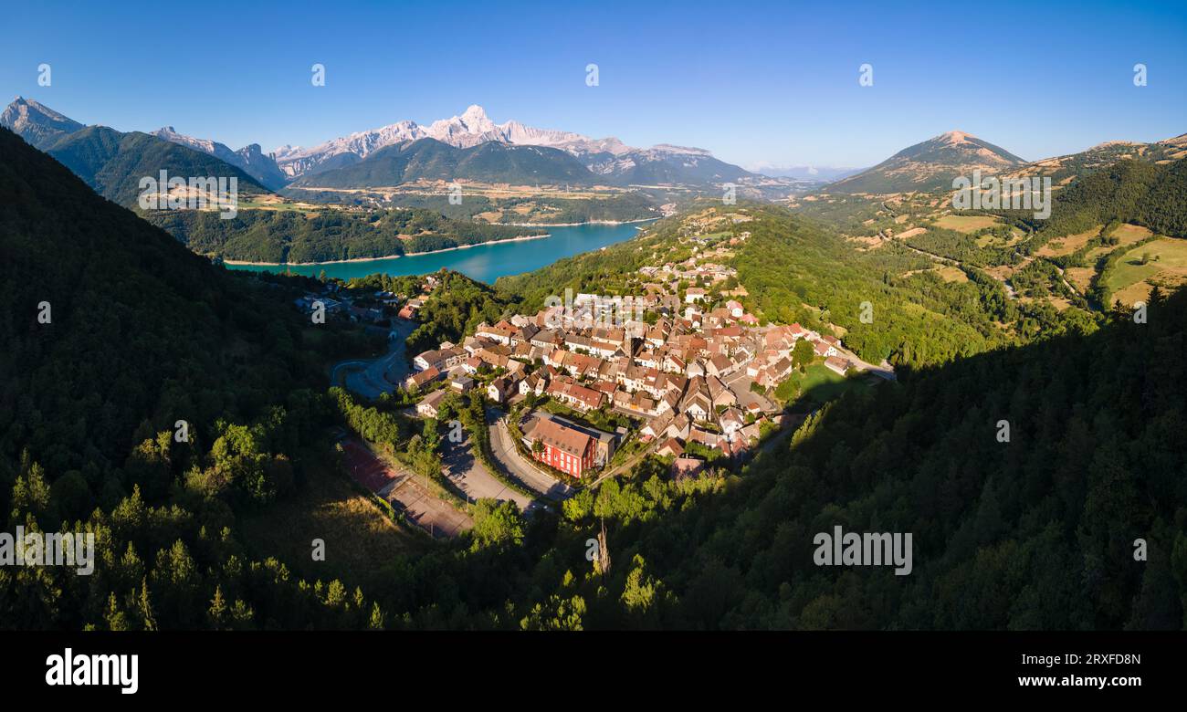 Aerial view of the village of Corps with Sautet Lake. In the distance, the higest point in Devoluy mountain range, the Obiou peak. Isere, Alps, France Stock Photo